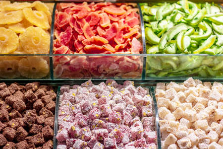Dried fruits and turkish delight on the counter. In different colors and nuts, such as walnuts, nuts.の写真素材