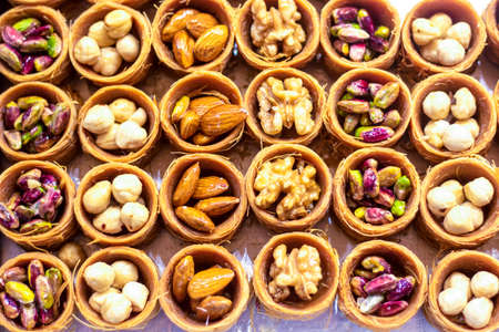 Round shredded wheat dessert of almonds, walnuts, hazelnutsの写真素材