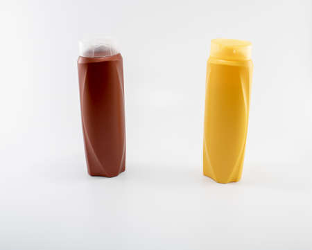 Shampoo, moisturizing bottles in brown, white, yellow colors. Shooting in white background.の写真素材
