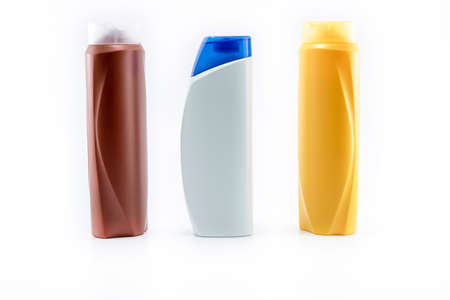 Shampoo, moisturizing bottles in brown, white, yellow colors. Shooting in white background.の写真素材
