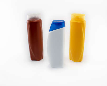 Shampoo, moisturizing bottles in brown, white, yellow colors. Shooting in white background.の写真素材