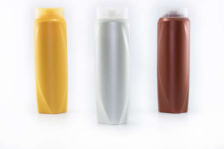 Shampoo, moisturizing bottles in brown, white, yellow colors. Shooting in white background.の写真素材