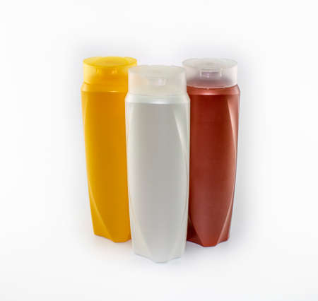 Shampoo, moisturizing bottles in brown, white, yellow colors. Shooting in white background.の写真素材