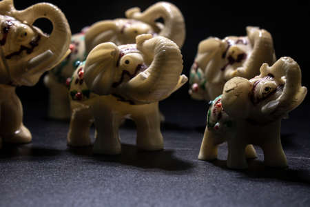 Herd of white-patterned elephants. Side shot. Black Backgroundの写真素材