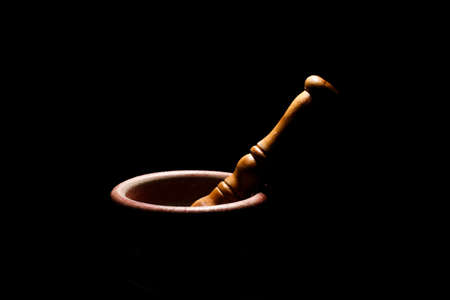 Mortar. Black background. isolated. Six dark. Light shoots from above.の写真素材