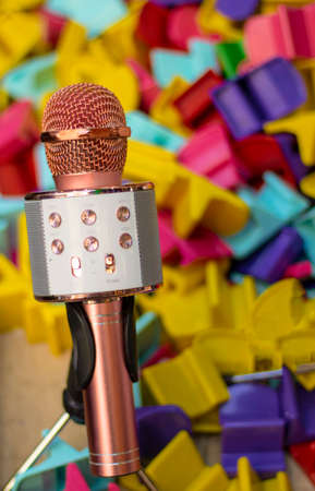 Karaoke microphone in pink and toy parts in background...の写真素材