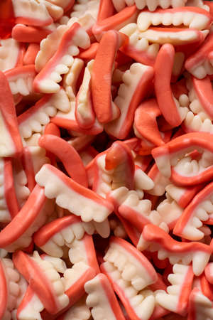 Jellybeans in the form of teeth. White and light red. Close-up shot of front of store.の写真素材