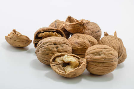 Broken walnut shells. Studio shoot on white background.