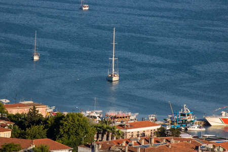 Sailboats on sea and ships anchored in port. It was taken from a high hill.の写真素材