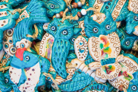 Ceramic owl figure. Blue eyes shaped evil eye beads.の写真素材