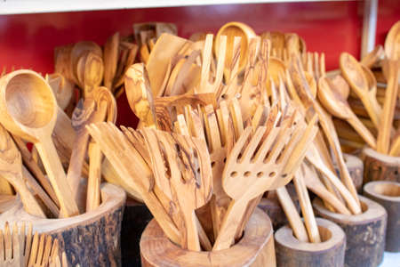 Wooden spoons and fork. Close-up. Close-up in light brown color.