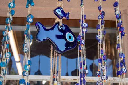 Traditional evil eye bead. Souvenir. Blurred background. To bring good luck