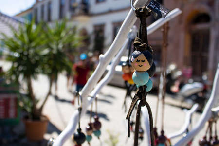 Keychains made of wooden beads. On the beads is a picture of a slanted lady in the Asian region.の写真素材