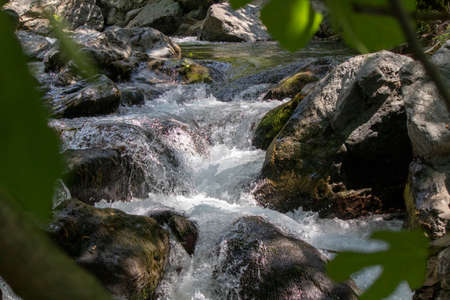 Clean water flowing between cliffsの写真素材