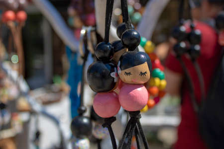 Keychains made of wooden beads. On the beads is a picture of a slanted lady in the Asian region.の写真素材