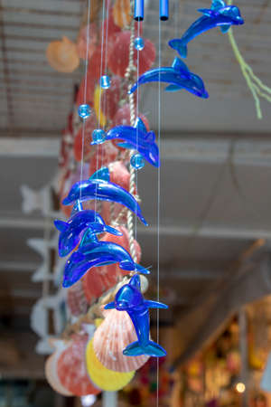 Hanging blue glass dolphin fishes. Ayvalik was taken on the island of Cunda.の写真素材