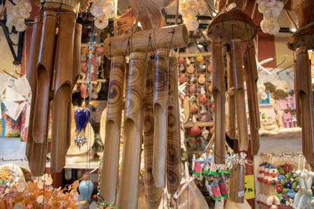 Hanging wooden wind bell. Close-up. Blurred background.の写真素材