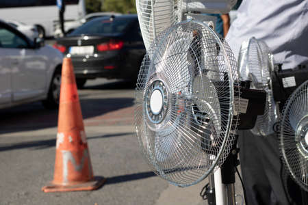 Close-up of the ventilator. In the background is a human body and vehicles passing by.の写真素材