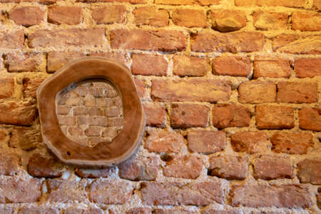 Mirror with wooden frame. Old brick wall in the background.の写真素材