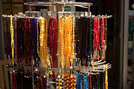 Rosary hanging on counter. Assortment of different colors. Symbolizes Islamic culture.の写真素材
