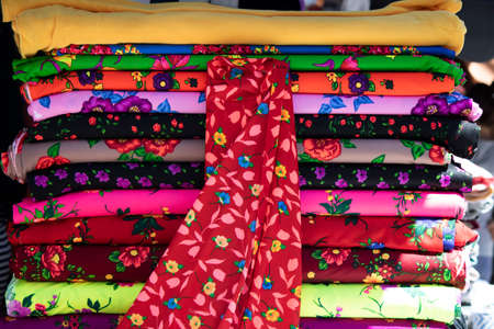 shawl hangers of various colors were filmed in front of the store. hangers of various colors were...