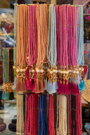 Hanging rosaries in different patterns and colors.の写真素材