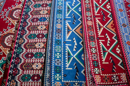 Close-up of Iranian rugs in different colors and patterns. Geometric patterns on.の写真素材