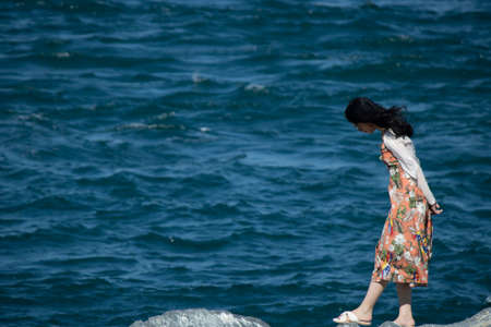 Walking at the seaside. Weather is windy.の写真素材