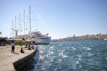 Eminonu, Istanbul, Turkey - July 29, 2019: Sailboat with France flags docked at Eminonu pier. People...