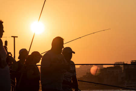 Istanbul, Turkey - September-11..2019: Men fishing on the Sarayburnu. It was taken during sunset.のeditorial素材