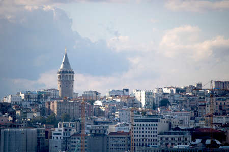 Istanbul, Turkey - September-11.2019: Ferry passing under the Galata Bridge. Opposite the Karakoy beach and above are the galata tower.のeditorial素材