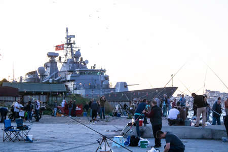 Istanbul, Turkey - September-28.2019: In the area fishermen are hunting fish anchored warship to the...