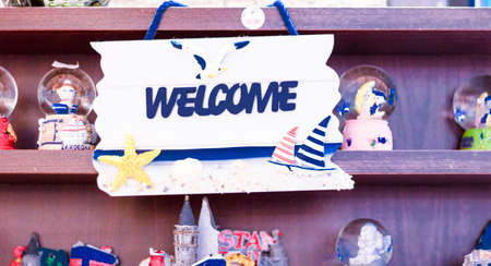 Welcome sign written on the signboard hanging in front of the shelf. Decorafit matched. Behind the shelves of snow curtains are standing as ornaments.の写真素材
