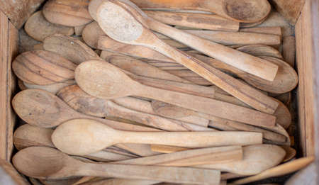 Box of wooden spoons close-up. It was taken in the shop in front of the store. It's used for cooking.の写真素材