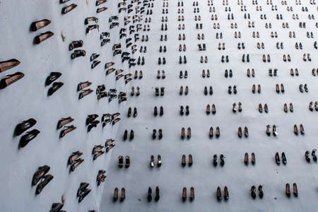 440 womens shoes were hung on the wall against the murders killed by their wives. To draw attention to murdered women.のeditorial素材
