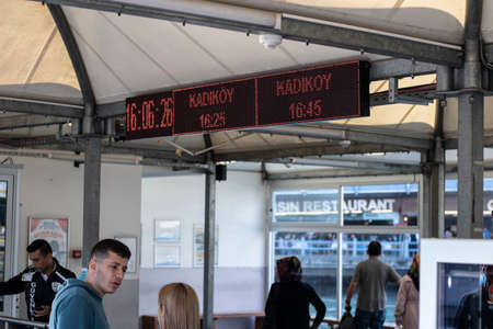 Kadikoy ferry pier. On the shore of Eminonu, passengers enter for a ferry ride. On the top of the led sign is watches and kadikoy.のeditorial素材