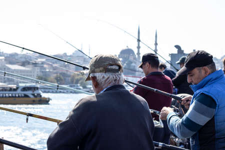 Fishermen and tourists are on the Galata Bridge in Istanbul, Turkey. It is a famous landmark of Istanbul. Galata Bridge with lot of people in historical center of Istanbul.のeditorial素材