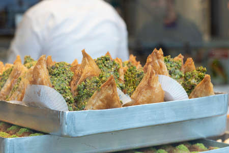 Pistachio baklava varieties. He was pulled out of the window. People working in the background....