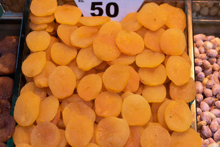 Dried apricots. It was taken in front of the market. There is a price tag on the back. Close up.の写真素材
