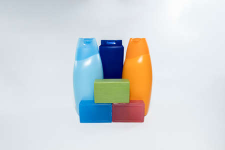 Close-up of soap and shampoo bottles in 3 different colors. Soap on the front and shampoo skewers on the back. Photographed in white background and in the studio.の写真素材