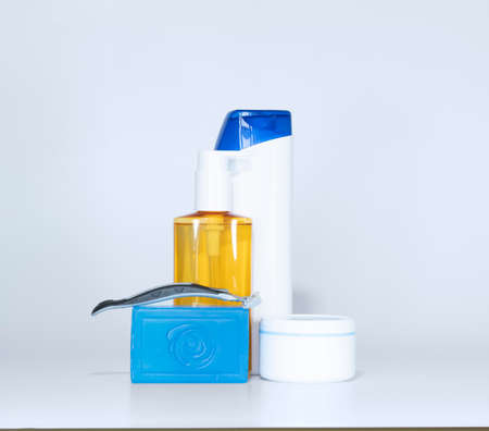 Shampoo bottles and razor blade close-up for male. A photo was taken in the studio. White background.の写真素材