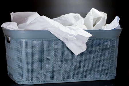 Linen prepared for washing in a basket with washing means .の写真素材