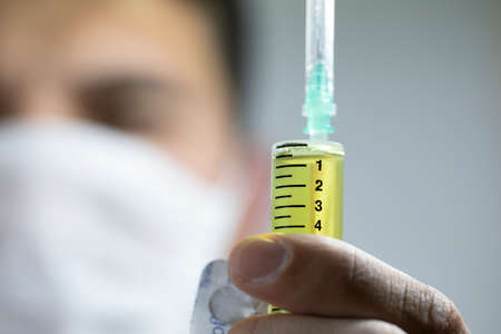 Concept consisting of syringes and pills. The photo was photographed in the studio.の写真素材