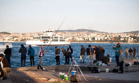 Istanbul, Turkey - November-02.2019: People walking and fishing on the beach and coming to have a...