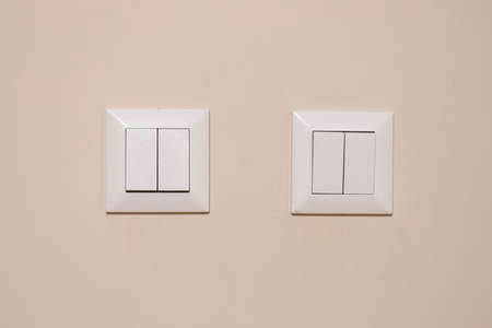 4 lamp switches close-up. They have a white color and are dirty and used.の写真素材