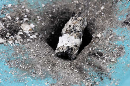Shooting ash macro shot. There is ash in the middle of the ashtray in the middle of the hole.の写真素材