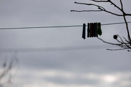 Rope hanging pegs. Photographed in the courtyard in front of the house. Close up.の写真素材