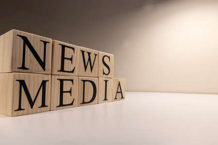 News and media text from wooden cubes. On a white background. Close-up.の写真素材