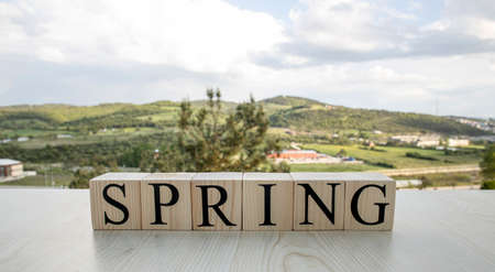 Spring, text on wooden cubes on rusty white painted iron. Conseptの写真素材