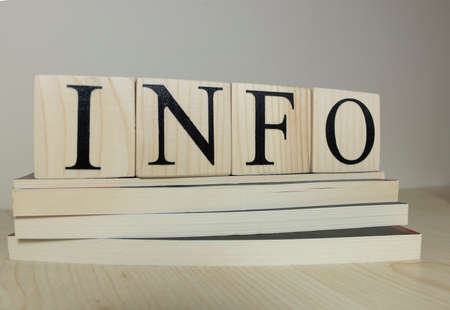 It writes the words info, success, work on the cubes on the wooden table. Consept